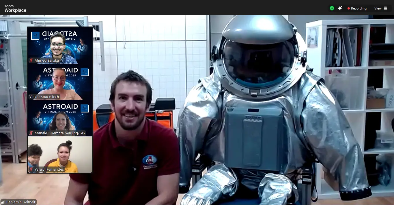 A presenter beside an analogue spacesuit